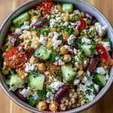 Sun-drenched Mediterranean Pearl Couscous with briny kalamata olives and crumbled feta, perfect for a fresh, easy vegetarian lunch.
