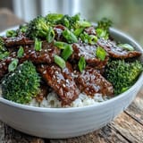 Garnished with green onions and sesame seeds, this Beef and Broccoli Bowl is ready to serve for dinner.