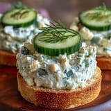 Bright green Benedictine spread tops crispy bread in these Derby Day Canapés.