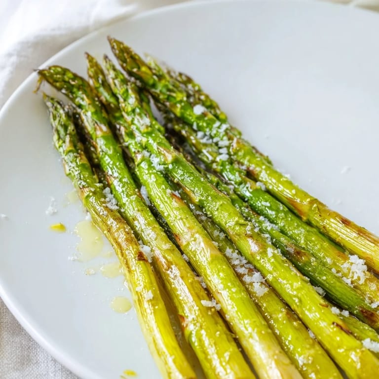 A platter of vibrant green grilled asparagus, perfect as a side dish, ready to be enjoyed.