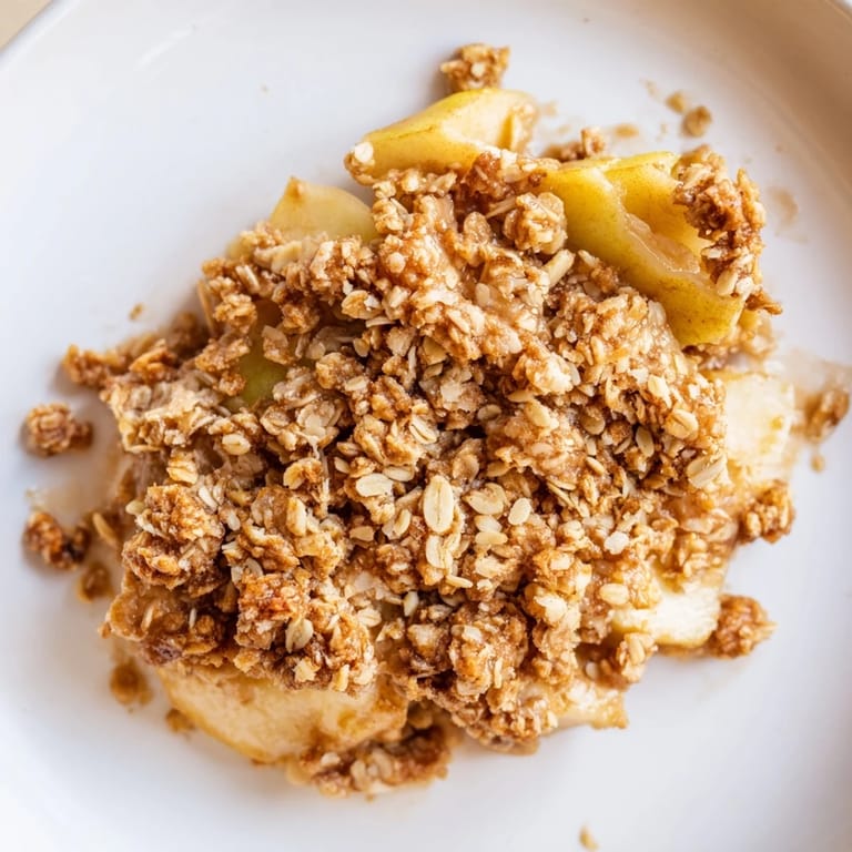 Freshly baked apple crumble, with a flaky, buttery topping over spiced, tender apples.